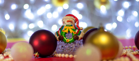 banner with Snowman with blur Christmas balls and Christmas beads on bokeh background. Christmas background or Christmas card. New Year or Xmas concept. Copy spaseの写真素材