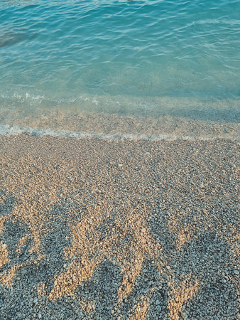 vertical photo of clear blue sea and pebble beach. summer beach holiday concept. soft focus. copy spaceの写真素材