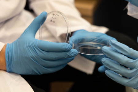 Scientist Works with Petri Dishes
