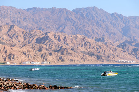 Fishing boats on Red Sea and scenic Sinai mountains landscape in Egypt.