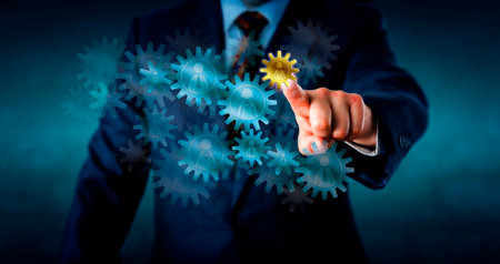 Recruitment consultant is selecting a small golden cog wheel embossed with a female worker icon from a host of virtual cogs forming a gear train. Concept for human resources decision and hiring.の写真素材