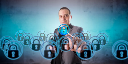 Business manager with positive face is picking one virtual lock icon among a crowd of multiples. Information technology concept for virtualization, data privacy, and information security management.の写真素材