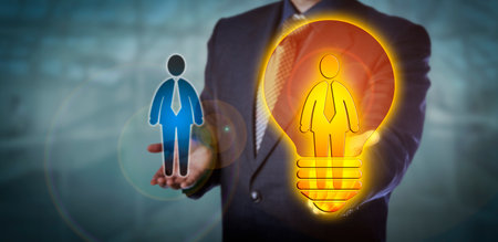 Unrecognizable recruiter is presenting a bright recruitment choice in form of a worker icon inside a lightbulb. HR concept for talent management, promotion, leadership, career move and success.の写真素材