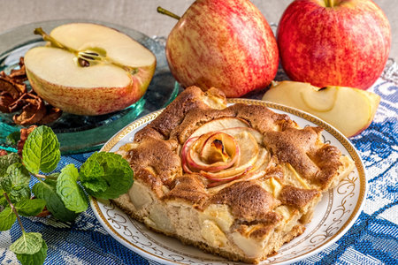 Tasty Apple Pie Piece on a Plate with Apple, Apple slices and mint leavesの写真素材