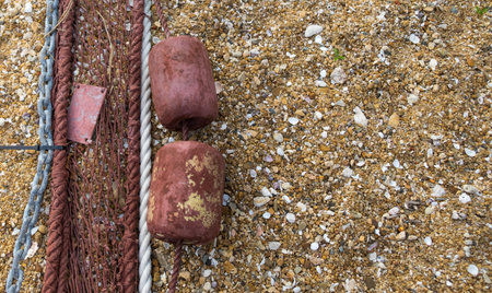 A part of safety net with float balls on sand beach. Detail. Copy space.の写真素材