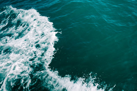 Dark blue sea foaming waves. Abstract textrured natural background with lot space for text. Template...