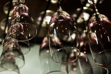 Empty glasses on black background. Artificial lighting creates reflections and glares in glass....