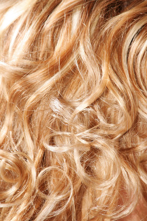 Golden women hair close-up background with wave の写真素材