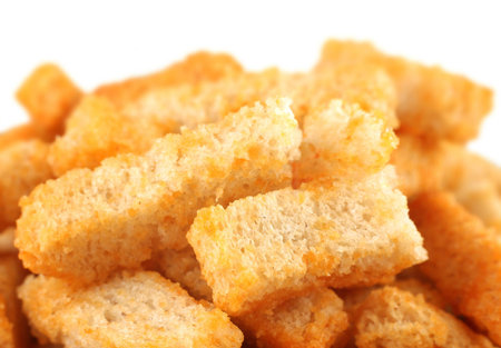 Yellow crouton fried bread slice closeup backgroundの写真素材