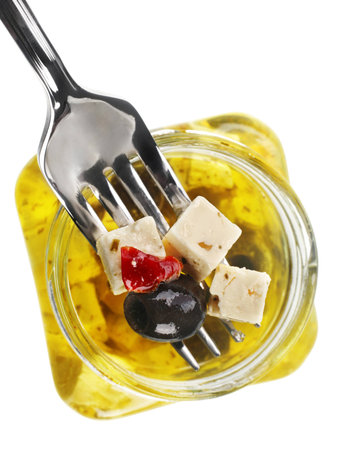 Cheese feta with olive and spice in oilの写真素材