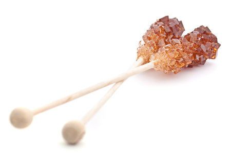 Brown amber sugar crystal on wood stickの写真素材