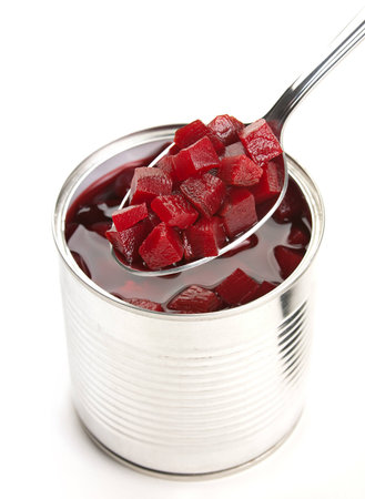 Beet slice preserved in metal spoon on whiteの写真素材