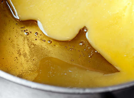 Melted honey and butter in metal panの写真素材