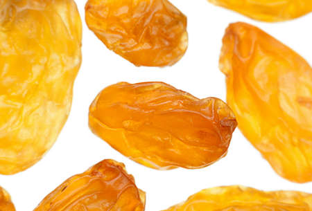 Yellow raisin closeup isolated on whiteの写真素材