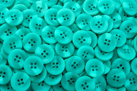 Green plastic button closeup horizontal background