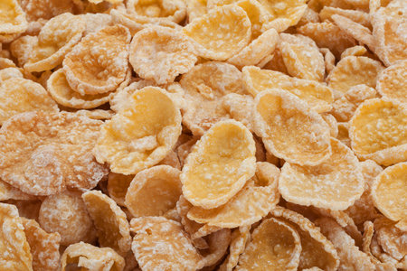 Sweet corn flakes in sugar glazed closeup background