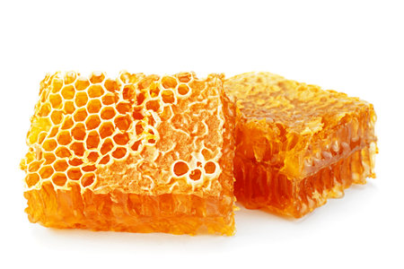 Yellow Honeycomb slice closeup isolated on white backgroundの写真素材
