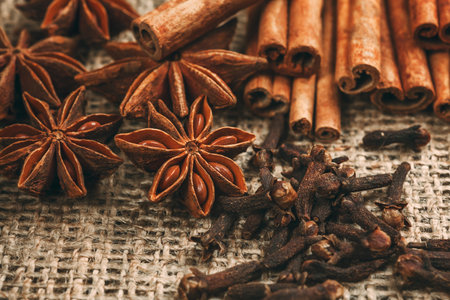 Spices and herbs. Food and cuisine ingredients. Cinnamon sticks, anise stars,  Cloves on textured backgroundの写真素材