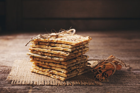 Dietary crunchy cracker with cereals (sunflower seeds, flax and sesame)  on a dark wooden background.の写真素材