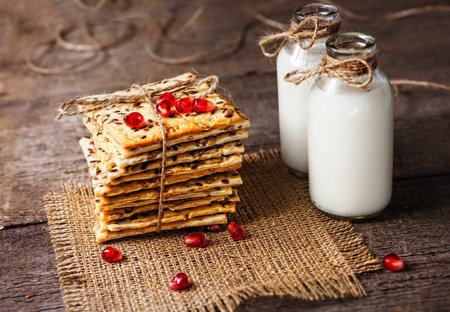 Dietary crunchy cracker with cereals and milk on a dark wooden background.の写真素材