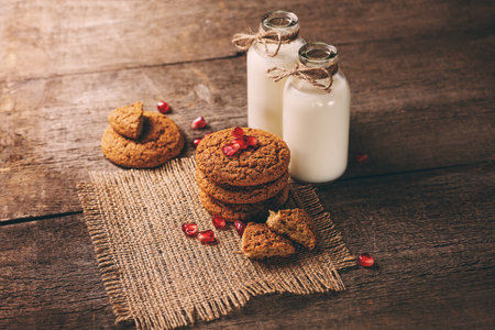 Drinking yogurt in bottles and cookies, selective focusの写真素材