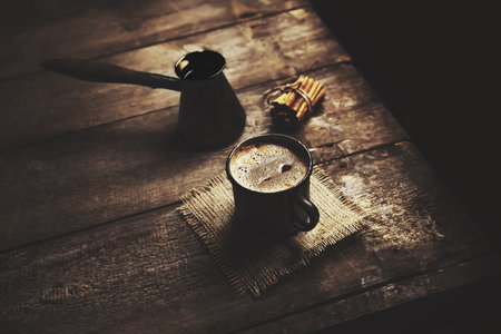 Old coffee cup and mill on dark rustic backgroundの写真素材