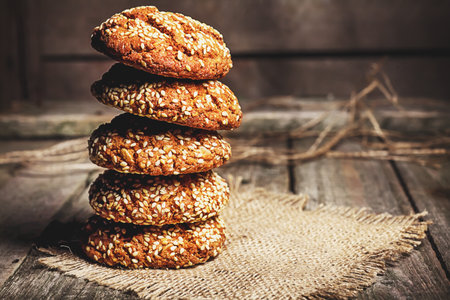 Homemade cookies with sesame, dark wood background, selective focusの写真素材
