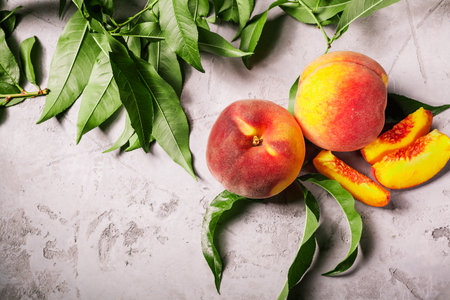 a lot of fresh peaches on a white tableの写真素材