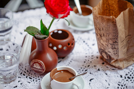 Cup of tasty hot chocolate on wooden background, closeup hot chocolate in white mug (shallow depth of field)の写真素材