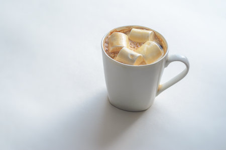 Cup Of Coffee with Marshmallows. White mug of hot drink with copy space background