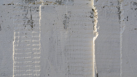 Texture of wooden formwork stamped on a raw concrete wall as background. Vertical strips from formworkの写真素材