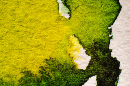 Green watercolor stain on embossed paper on white background. Abstract watercolor patternの写真素材