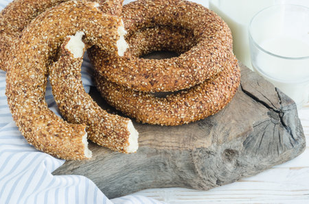 Turkish simit bagels with sesame on a wooden board. Milk Bottle, Glass, Cotton Fabricの写真素材