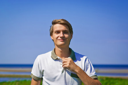 Portrait of young attractive smiling man outdoors
