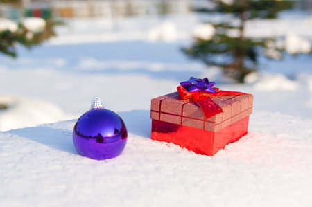 Christmas balls on snow outdoorsの写真素材