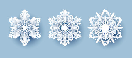 Vector set of 3 white Christmas paper cut 3d snowflakes with shadow on white background. New year and Christmas design elementsのイラスト素材