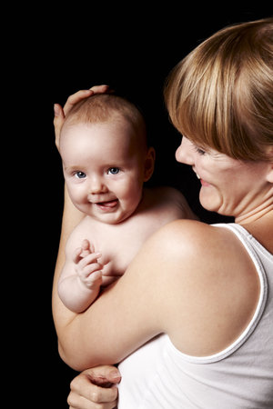 Mother holding her baby in her armsの写真素材