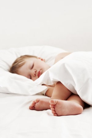 Baby sleeping in bedの写真素材