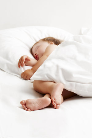 Baby sleeping in bedの写真素材