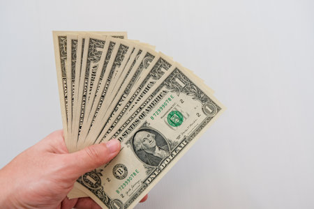 Hand hold USA One dollar banknote isolated on white background
