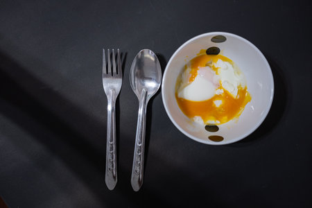 Soft-boiled eggs break when poured into a small white cup.Prepare to serve with a spoonの写真素材