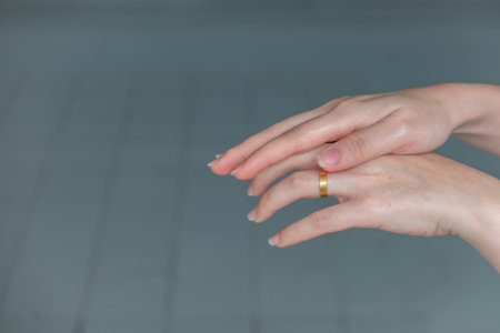 Woman washing hands rubbing with alcohol, which is key in efforts to halt the spread of Coronavirus