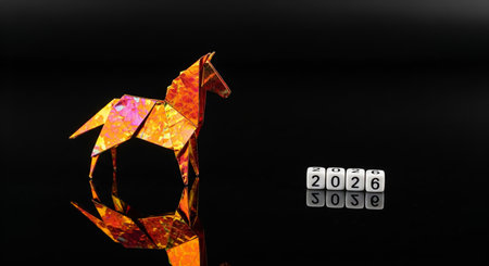 A colorful origami fire horse with the year 2026 on dice symbolizing the Chinese zodiac on a reflective black background with copy spaceの素材