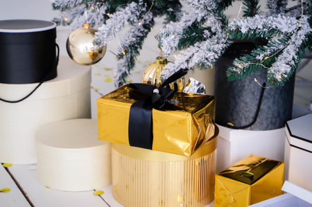 Pink present boxes with ribbons under the Christmas tree in Classic apartments with white interior....