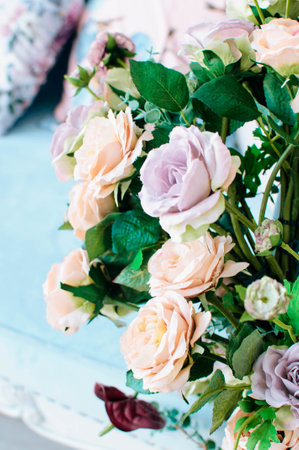 A closeup view of delicate white flowers blossoming on a tree branch against a backdrop of green grass and blue sky in a natural landscapeの写真素材