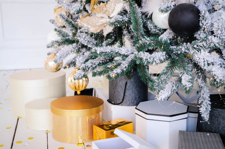 Pink present boxes with ribbons under the Christmas tree in Classic apartments with white interior. High quality photoの写真素材