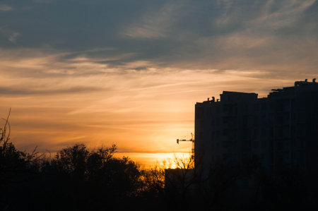 Sunrise over modern office buildings in business district center of Odesa. Skyline view of cityscape with sunlight and flare in warm light color tone. Construction business concept. High quality photoの写真素材