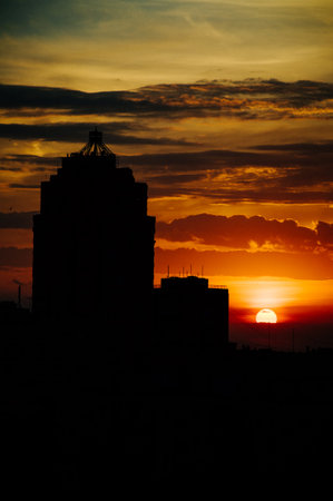 Sunrise over modern office buildings in business district center of Odesa. Skyline view of cityscape with sunlight and flare in warm light color tone. Construction business concept. High quality photoの写真素材