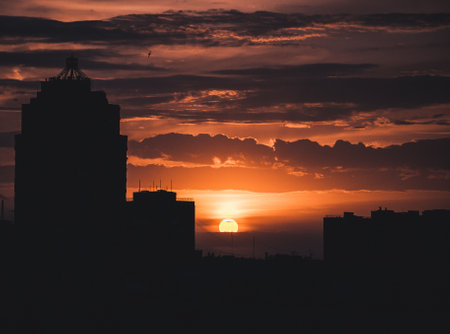 Sunrise over modern office buildings in business district center of Odesa. Skyline view of cityscape with sunlight and flare in warm light color tone. Construction business concept. High quality photoの写真素材