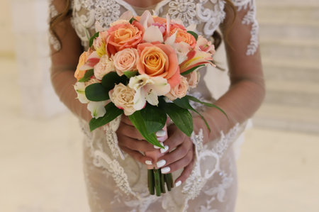 Bright Beautiful bridal bouquet with roses and ribbon. High quality photoの写真素材